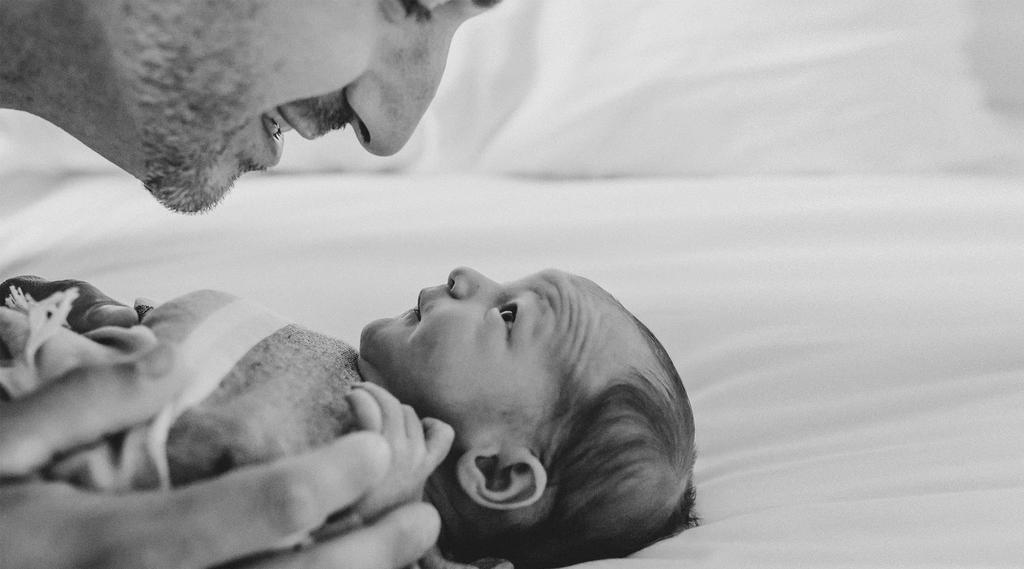 father singing to his baby black and white
