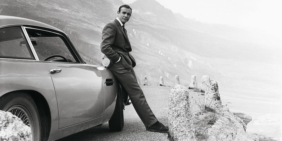 Sean Connery as James Bond in Goldfinger, next to the iconic 007 car