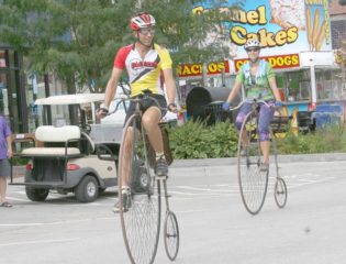 Randy Oleynik and his daughter riding their bikes in town