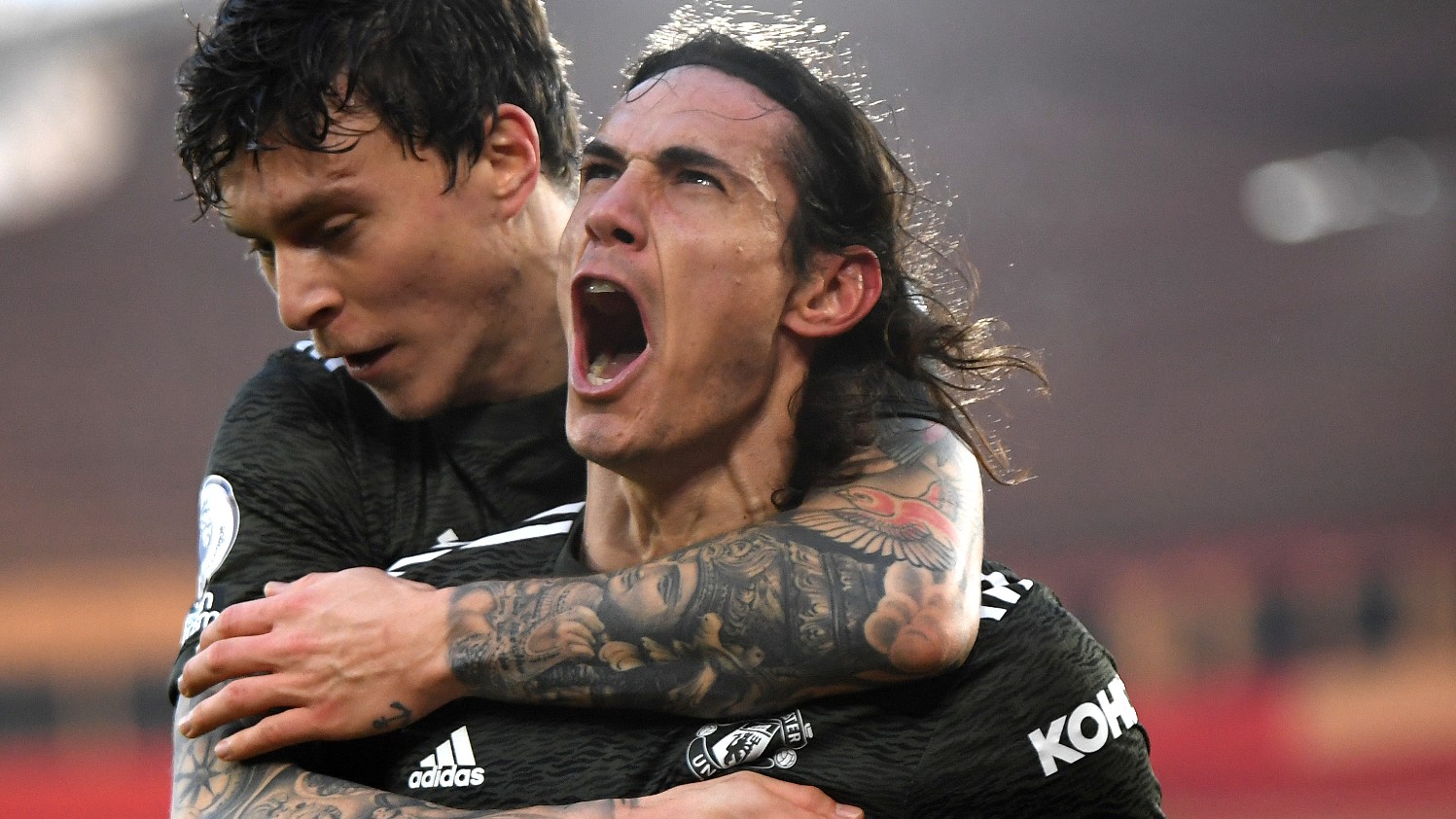 Uruguay striker Edinson Cavani celebrating a goal with Swedish defender Victor Lindelöf