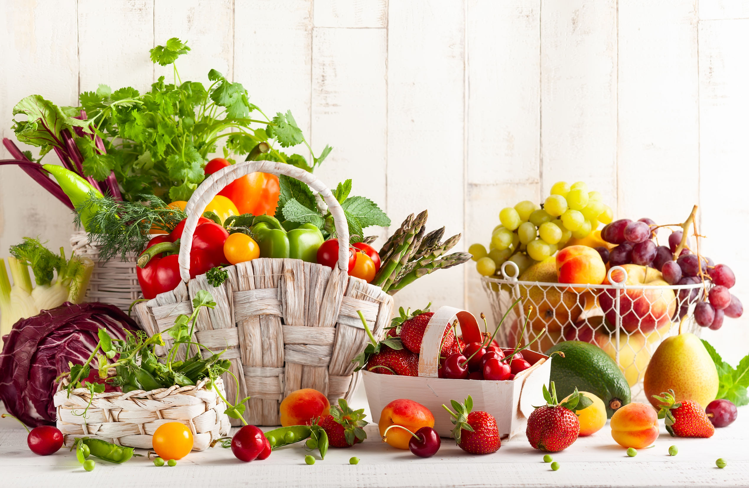 A variety of fruits and veggies arranged in baskets